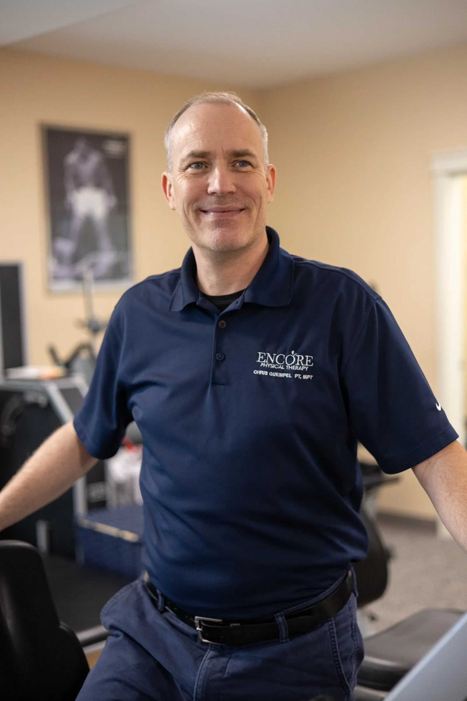 Chris Guempel, PT, MPT, standing in the Encore clinic gym