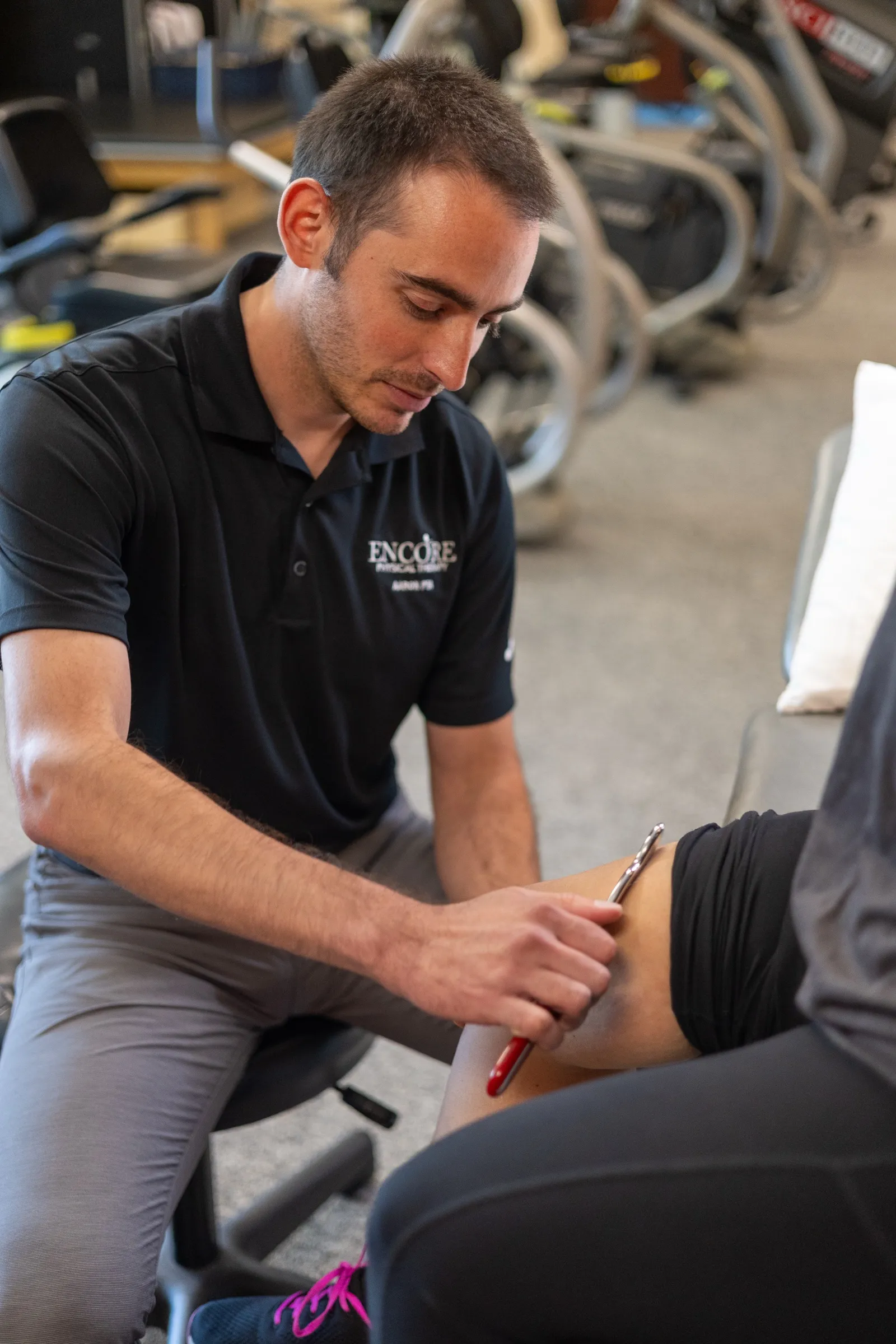 A therapist giving hands-on soft tissue treatment