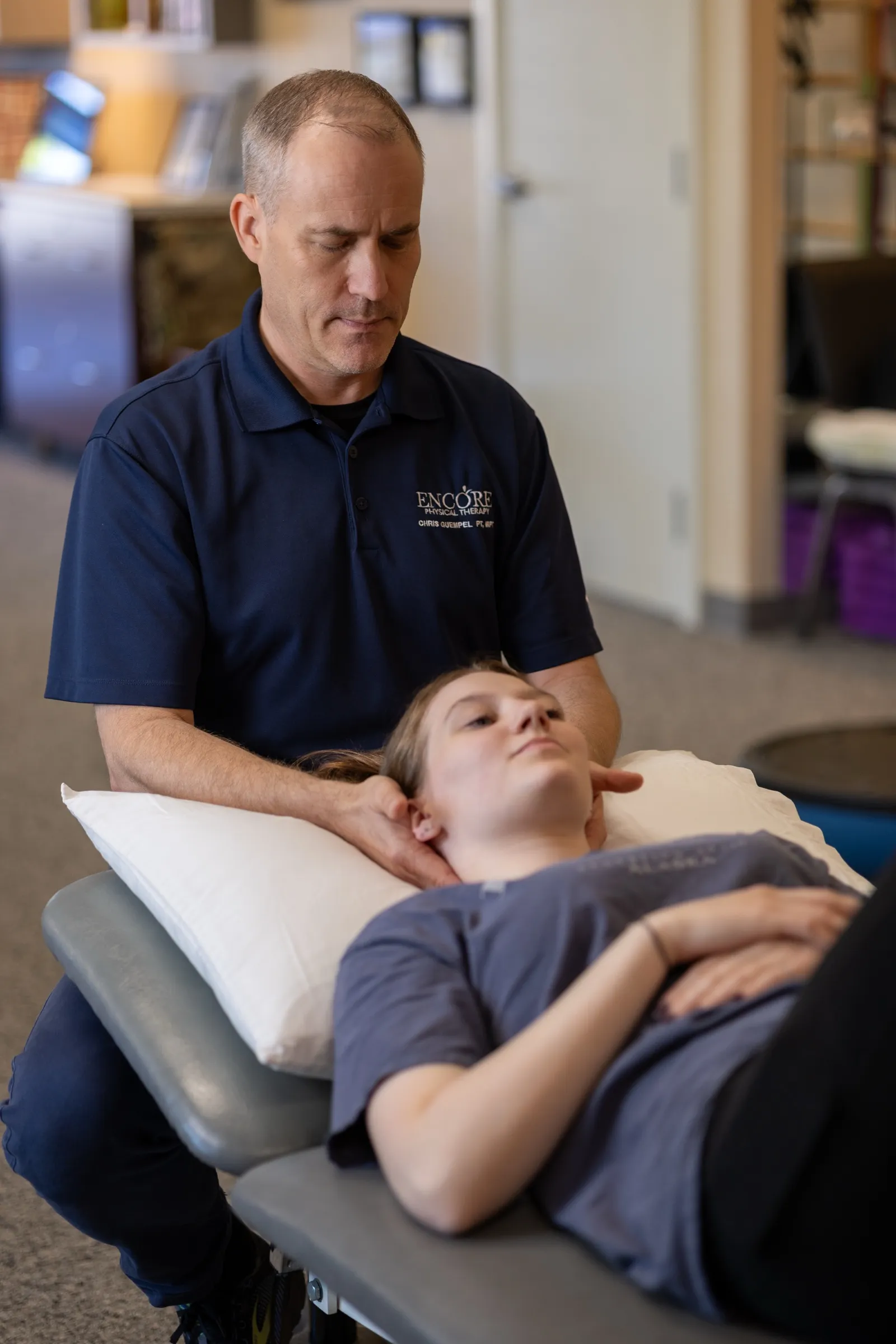 An Encore therapist performing manual therapy on a patient’s neck