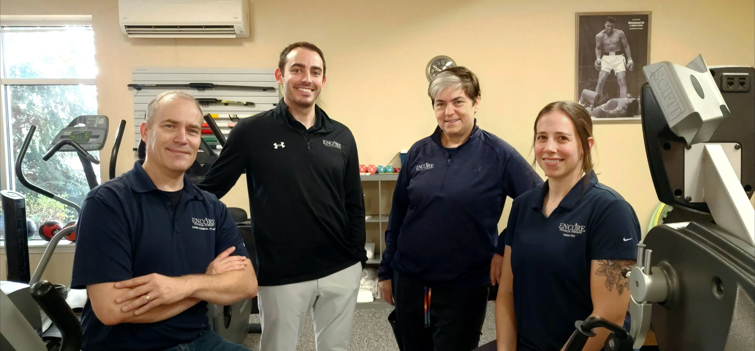The Encore Physical Therapy team standing together in the clinic gym