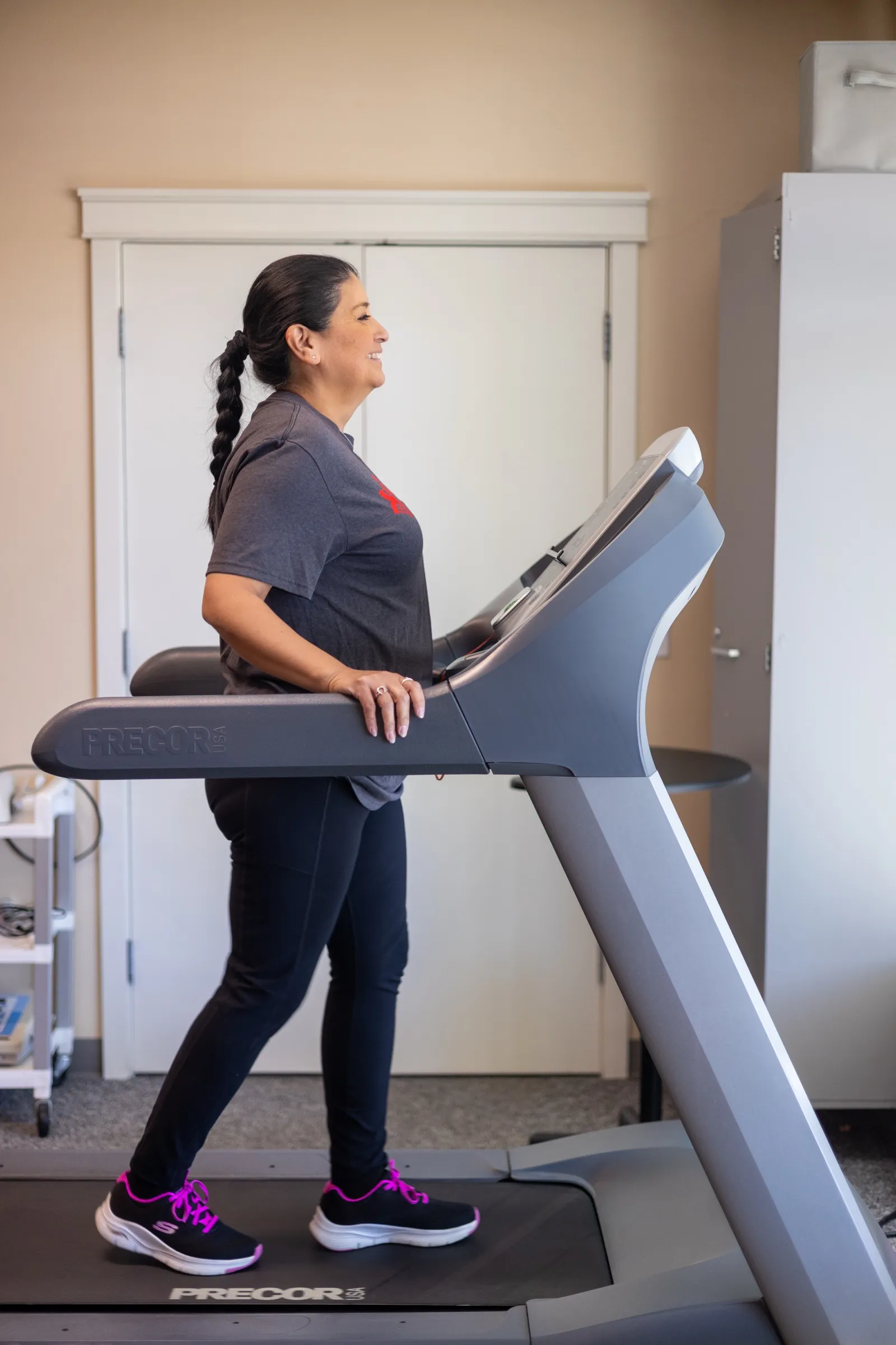 A patient walking on a treadmill during gait training